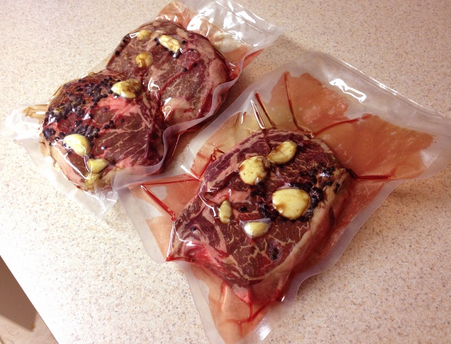The bagged meat, with peppercorns and garlic cloves.